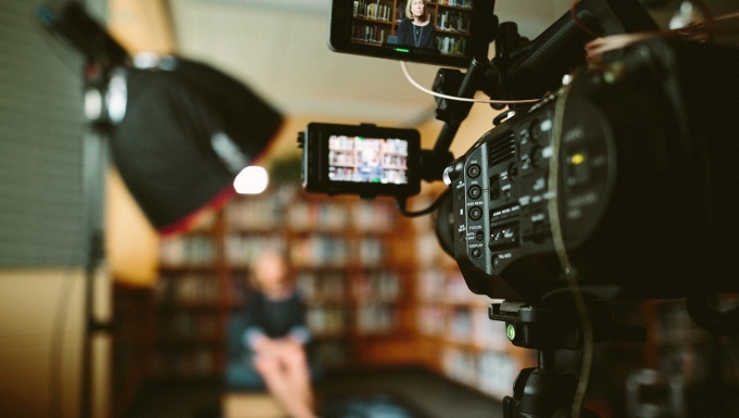CC0 Pixabay Une caméra au premier plan filmant une personne au second.