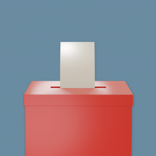 Un bulletin de vote introduit dans une urne.